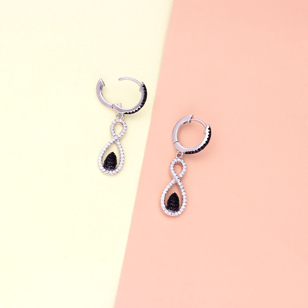 Flatlay view of Black and White Woven CZ Dangle Earrings in Sterling Silver