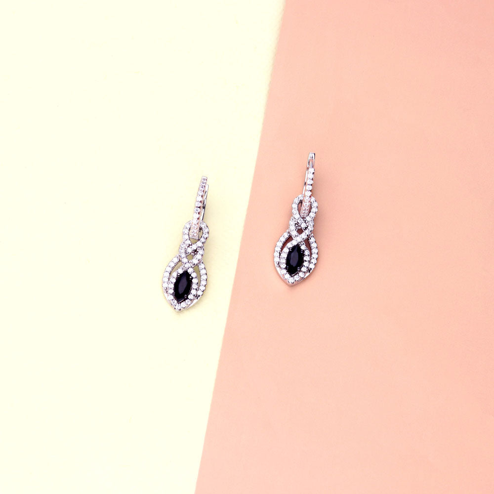 Flatlay view of Black and White Woven CZ Dangle Earrings in Sterling Silver