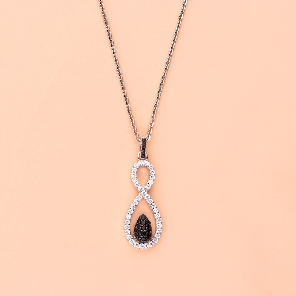 Flatlay view of Black and White Woven CZ Pendant Necklace in Sterling Silver