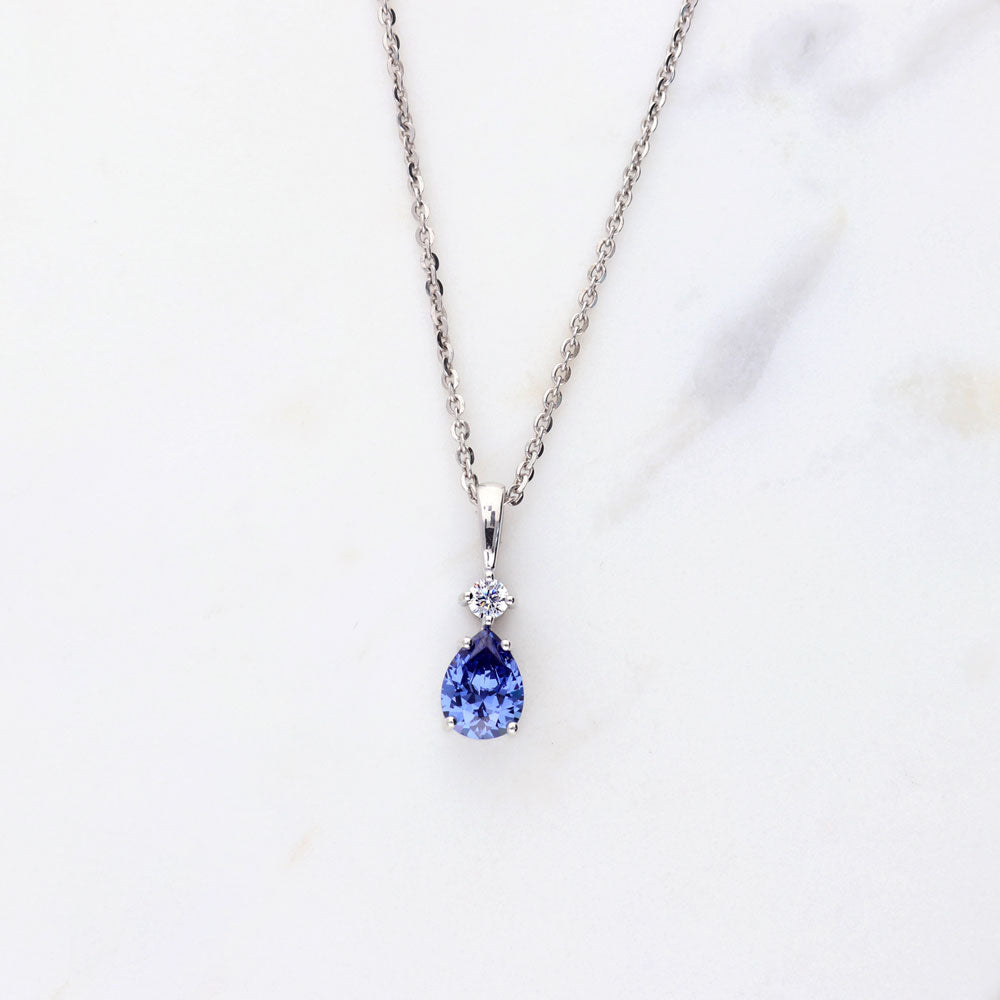 Flatlay view of 2-Stone Simulated Blue Tanzanite CZ Pendant Necklace in Sterling Silver