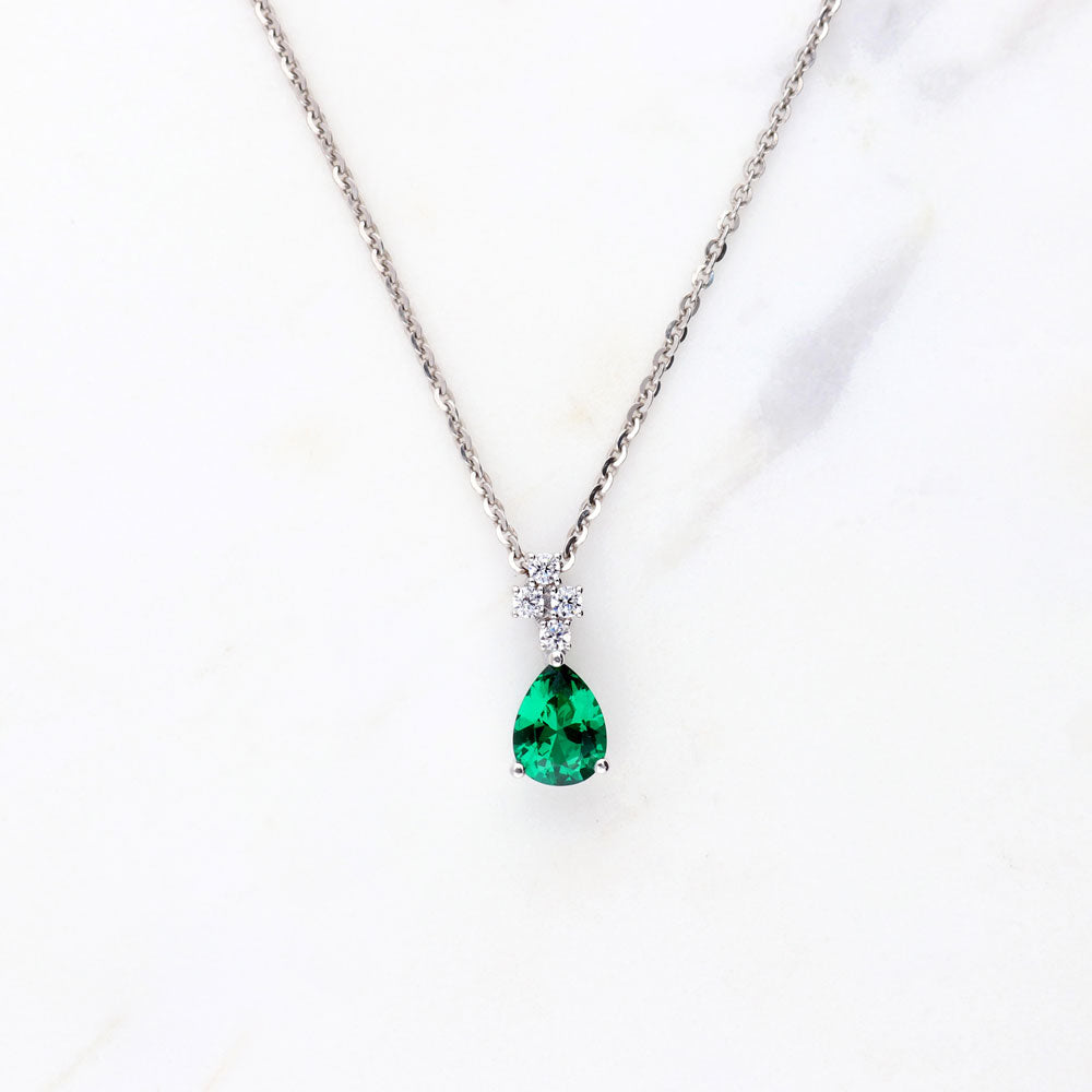Flatlay view of Cluster Simulated Emerald CZ Pendant Necklace in Sterling Silver