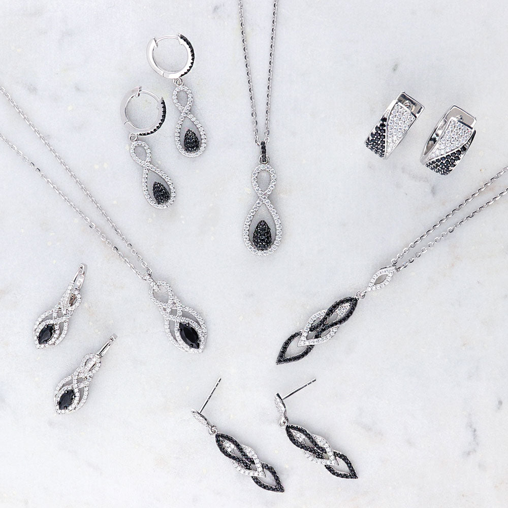 Flatlay view of Black and White Woven CZ Necklace and Earrings Set in Sterling Silver