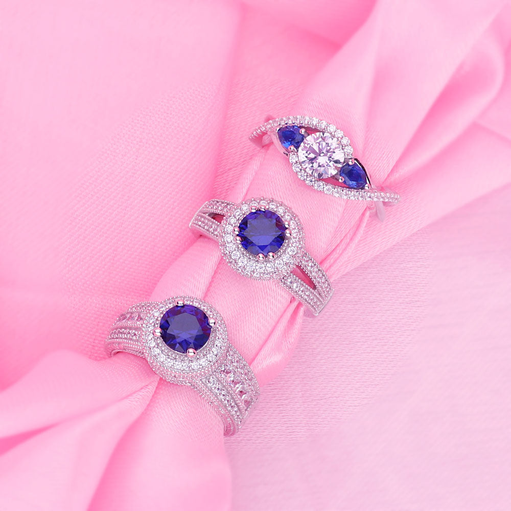 Flatlay view of Halo Milgrain Simulated Blue Sapphire Round CZ Ring in Sterling Silver