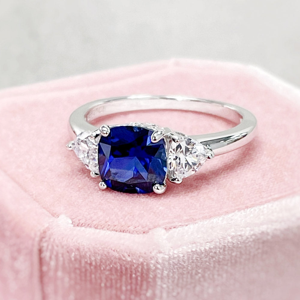 Flatlay view of 3-Stone Simulated Blue Sapphire Cushion CZ Ring in Sterling Silver