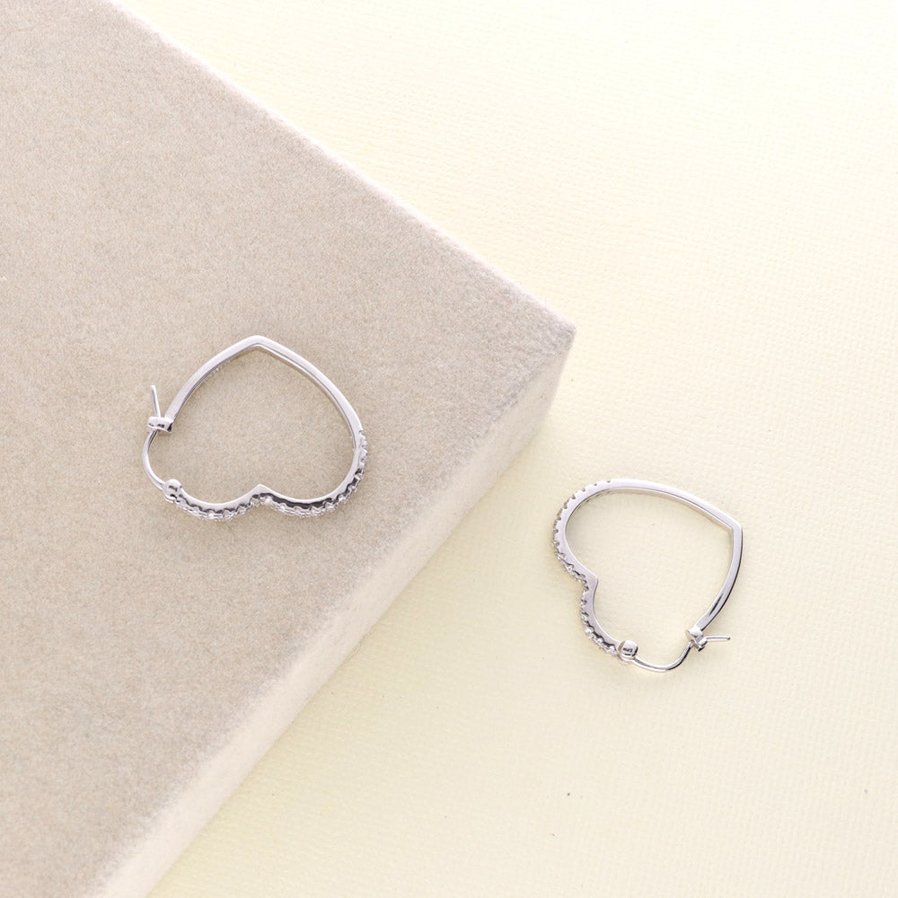 Flatlay view of Heart CZ Medium Hoop Earrings in Sterling Silver 1 inch