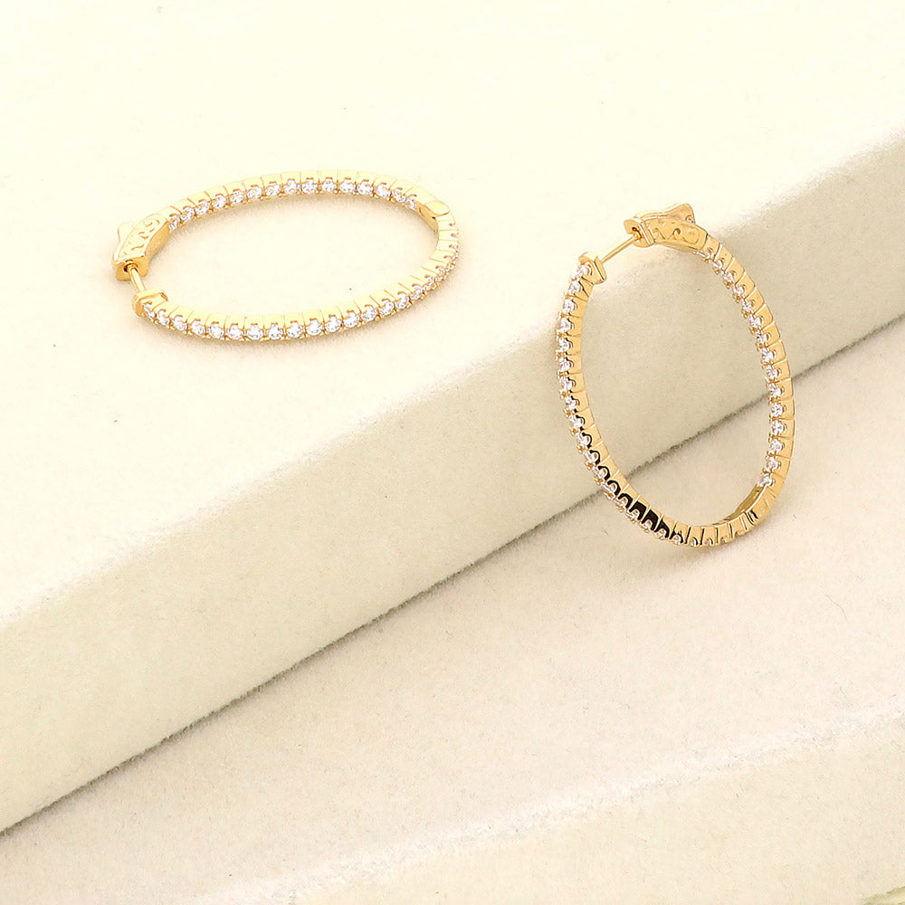 Flatlay view of Oval CZ Inside-Out Hoop Earrings in Sterling Silver 1.4 inch, Yellow Gold Flashed