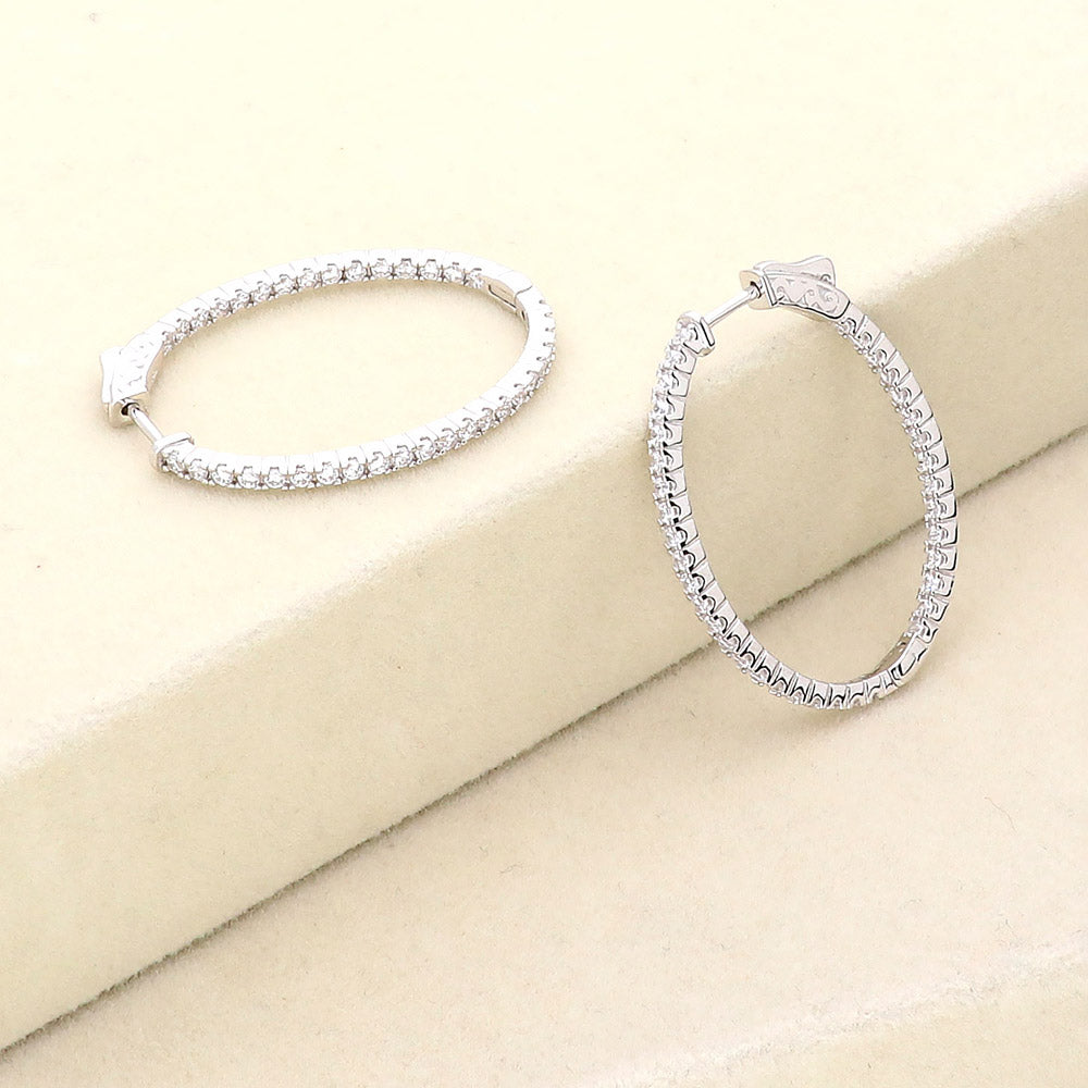 Flatlay view of Oval CZ Inside-Out Hoop Earrings in Sterling Silver, 2 Pairs