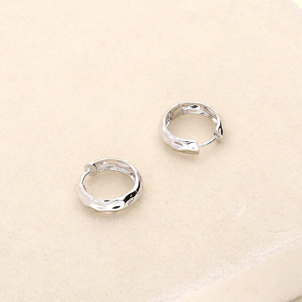 Flatlay view of Dome Hammered Medium Hoop Earrings in Sterling Silver 0.67 inch