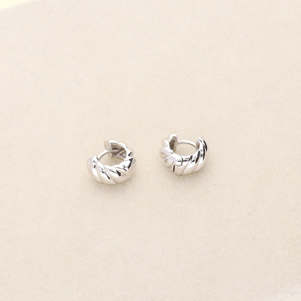Flatlay view of Cable Small Huggie Earrings in Sterling Silver 0.5 inch
