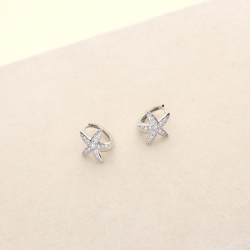Flatlay view of Starfish CZ Small Huggie Earrings in Sterling Silver 0.5 inch