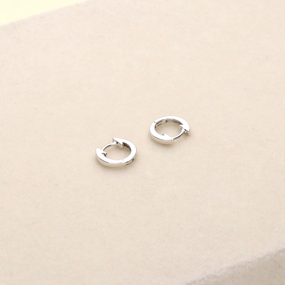 Flatlay view of Mini Huggie Earrings in Sterling Silver 0.45 inch