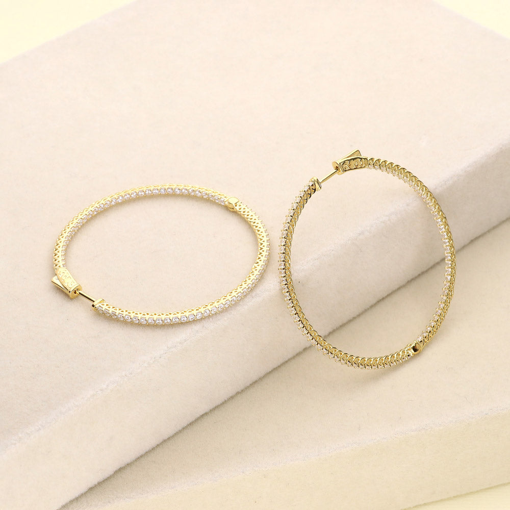 Flatlay view of CZ Large Inside-Out Hoop Earrings in Sterling Silver 2 inch