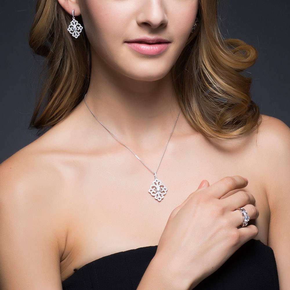 Model wearing Art Deco Filigree CZ Dangle Earrings in Sterling Silver