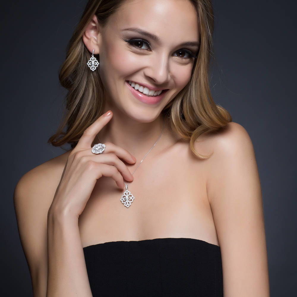 Model wearing Art Deco Filigree CZ Dangle Earrings in Sterling Silver