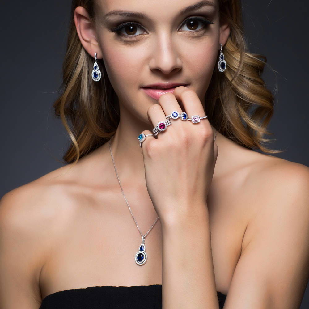 Model wearing Halo Simulated Blue Sapphire Oval CZ Set in Sterling Silver