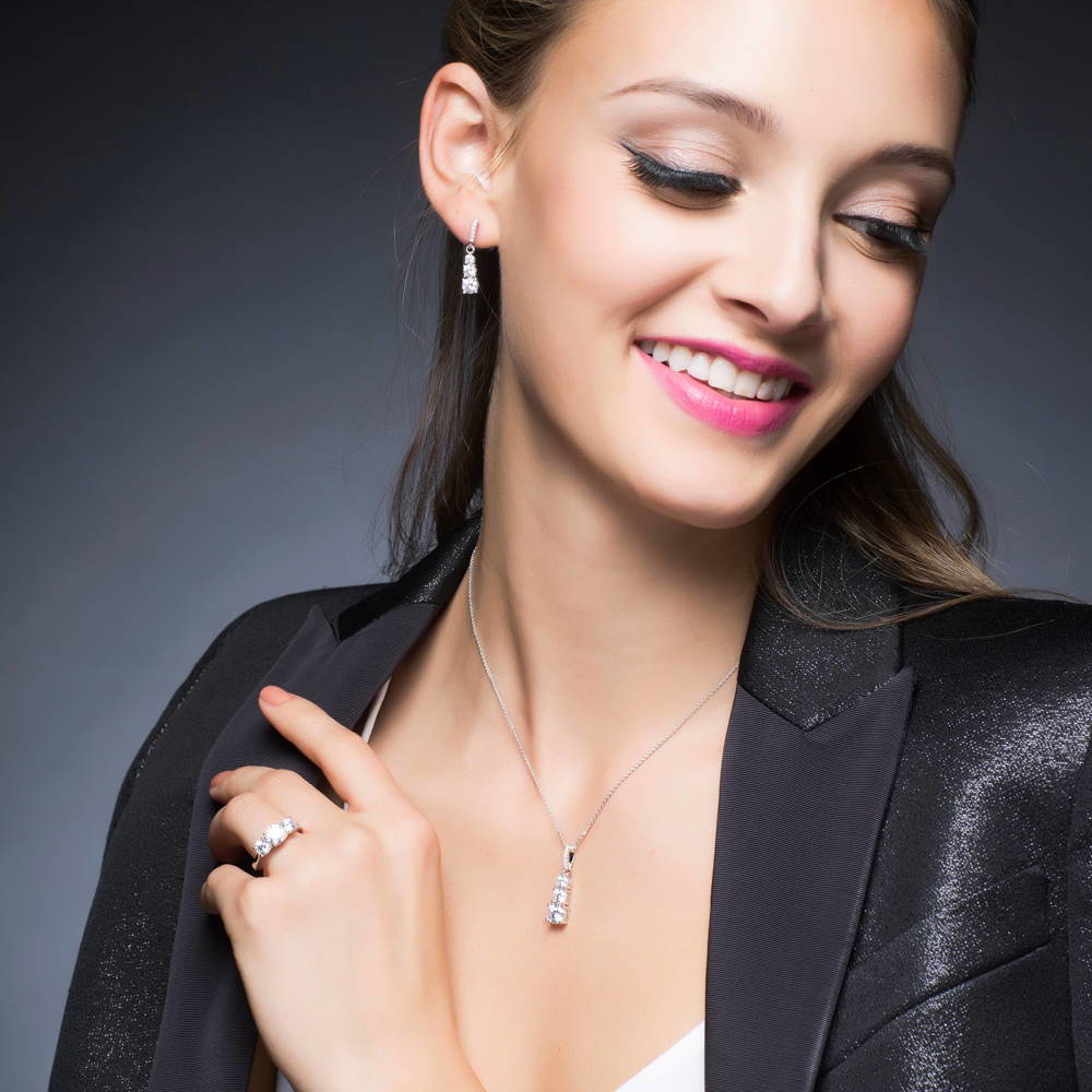 Model wearing 3-Stone Graduated Round CZ Pendant Necklace in Sterling Silver, 2 of 6