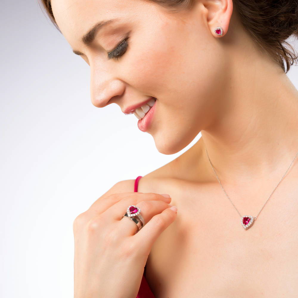 Model wearing Halo Heart Simulated Ruby CZ Statement Ring Set in Sterling Silver