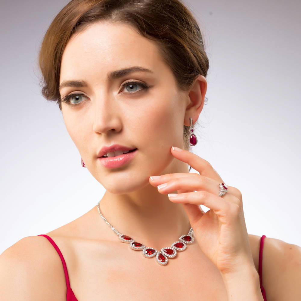 Model wearing Halo Simulated Ruby Pear CZ Set in Sterling Silver