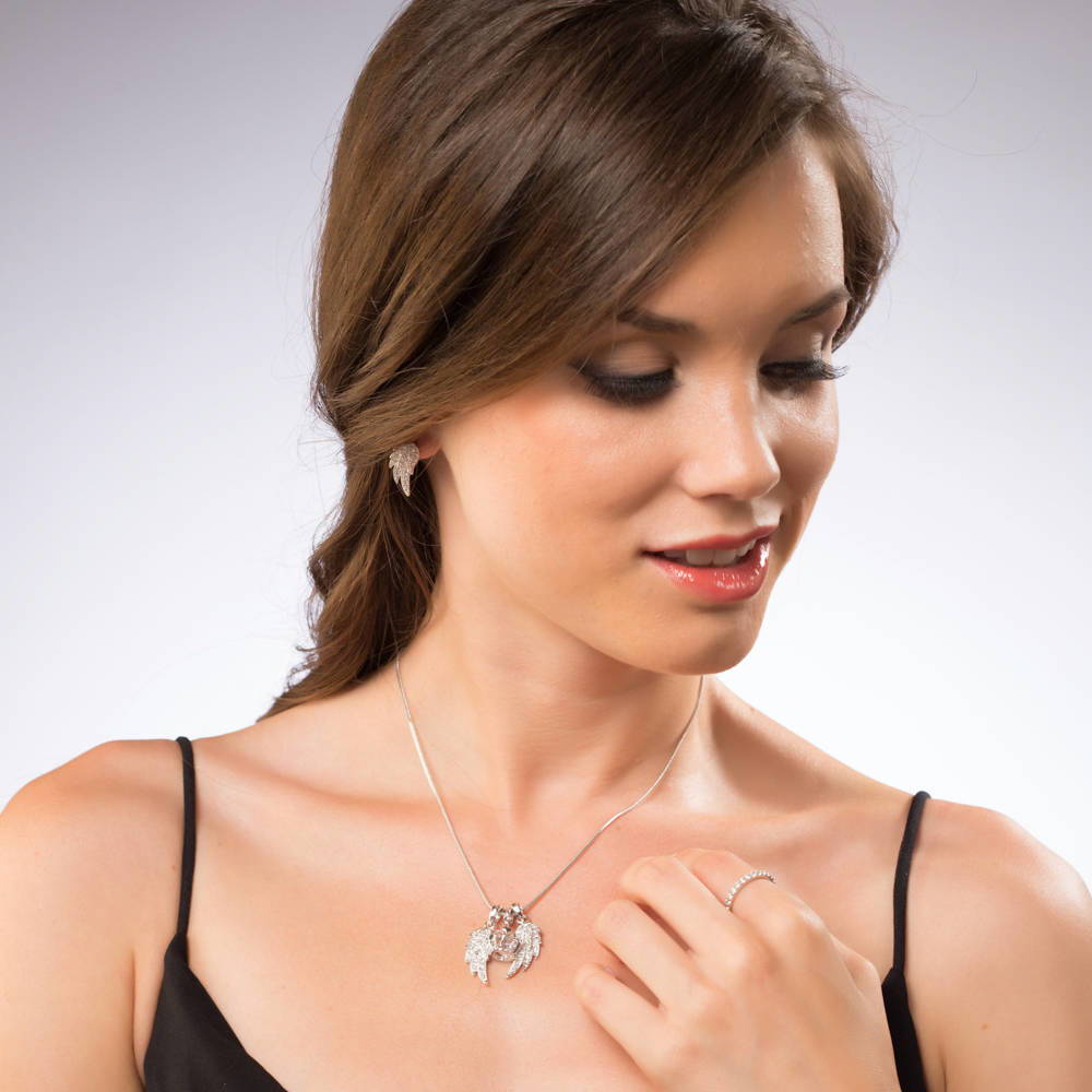 Model wearing Angel Wings CZ Stud Earrings in Silver-Tone