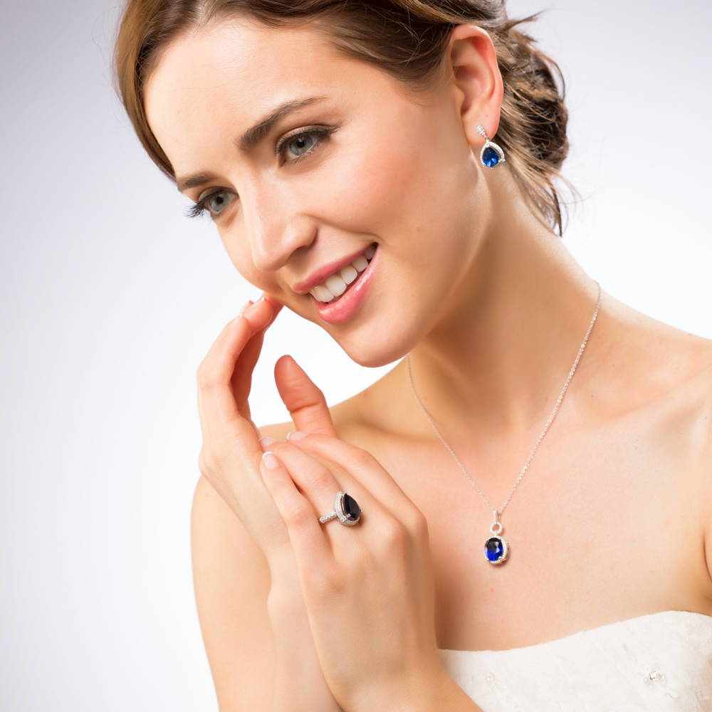 Model wearing Halo Simulated Blue Sapphire Oval CZ Necklace in Sterling Silver, 3 of 7