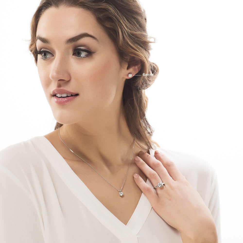 Model wearing Solitaire Round CZ Stud Earrings in Sterling Silver