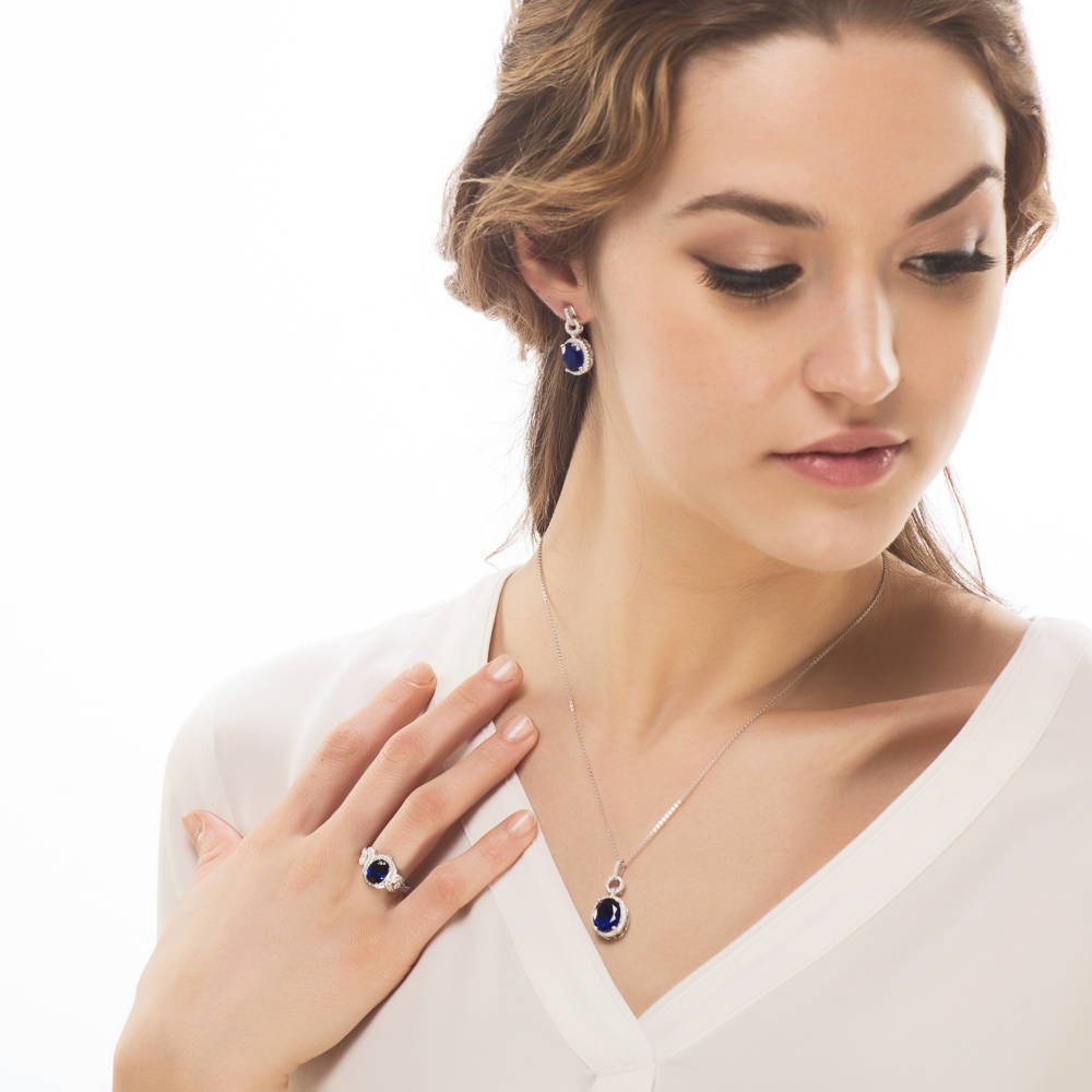 Model wearing Halo Simulated Blue Sapphire Oval CZ Set in Sterling Silver