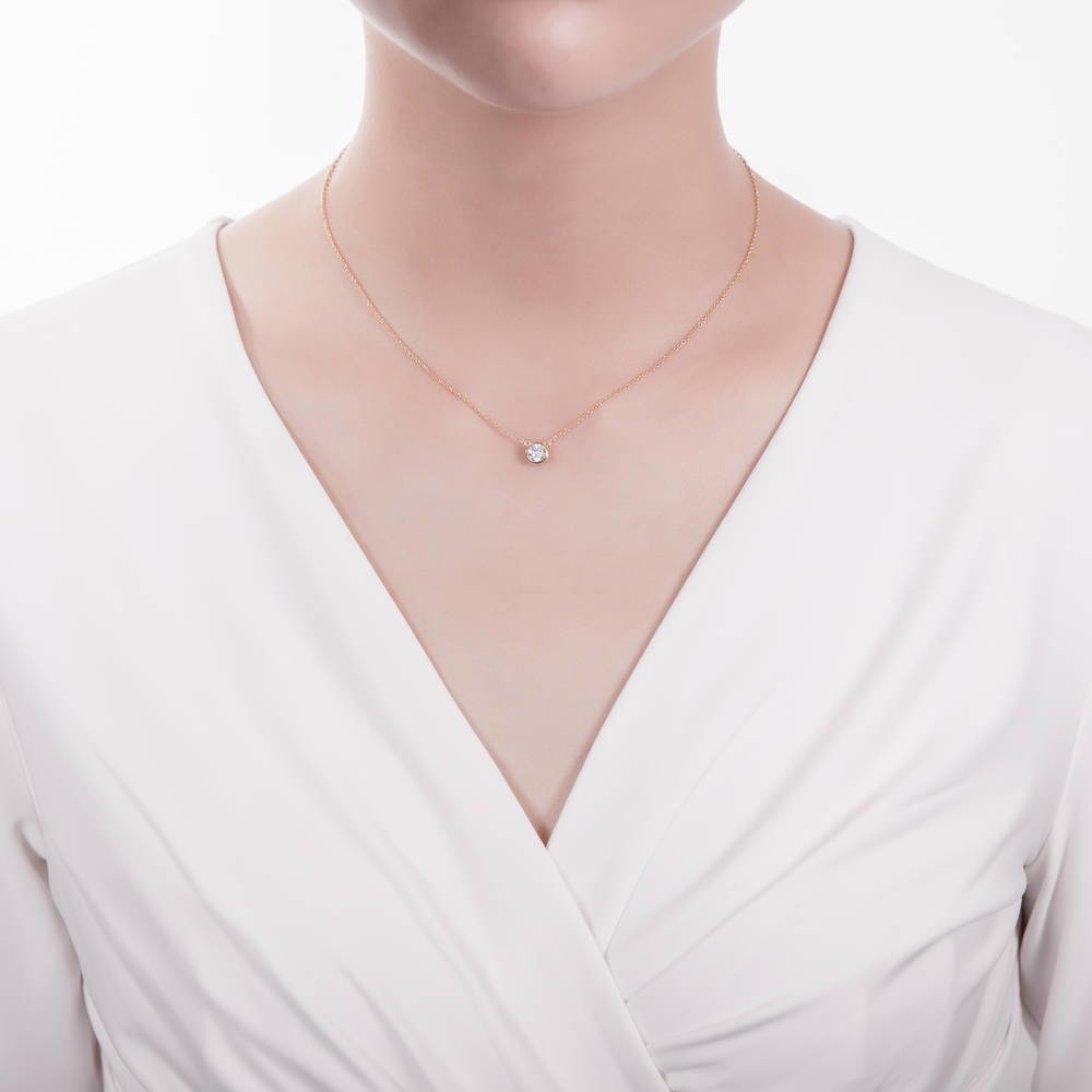 Model wearing Solitaire 0.45ct Bezel Set Round CZ Pendant Necklace in Sterling Silver, 2 of 6