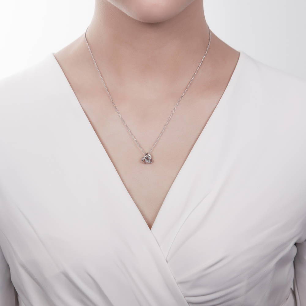 Model wearing Love Knot CZ Pendant Necklace in Sterling Silver, 5 of 9