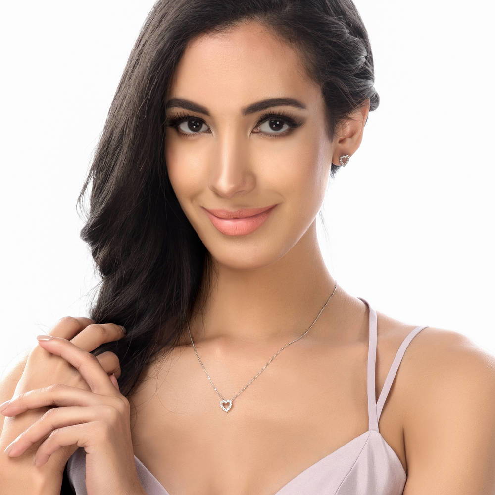 Model wearing Open Heart CZ Stud Earrings in Sterling Silver