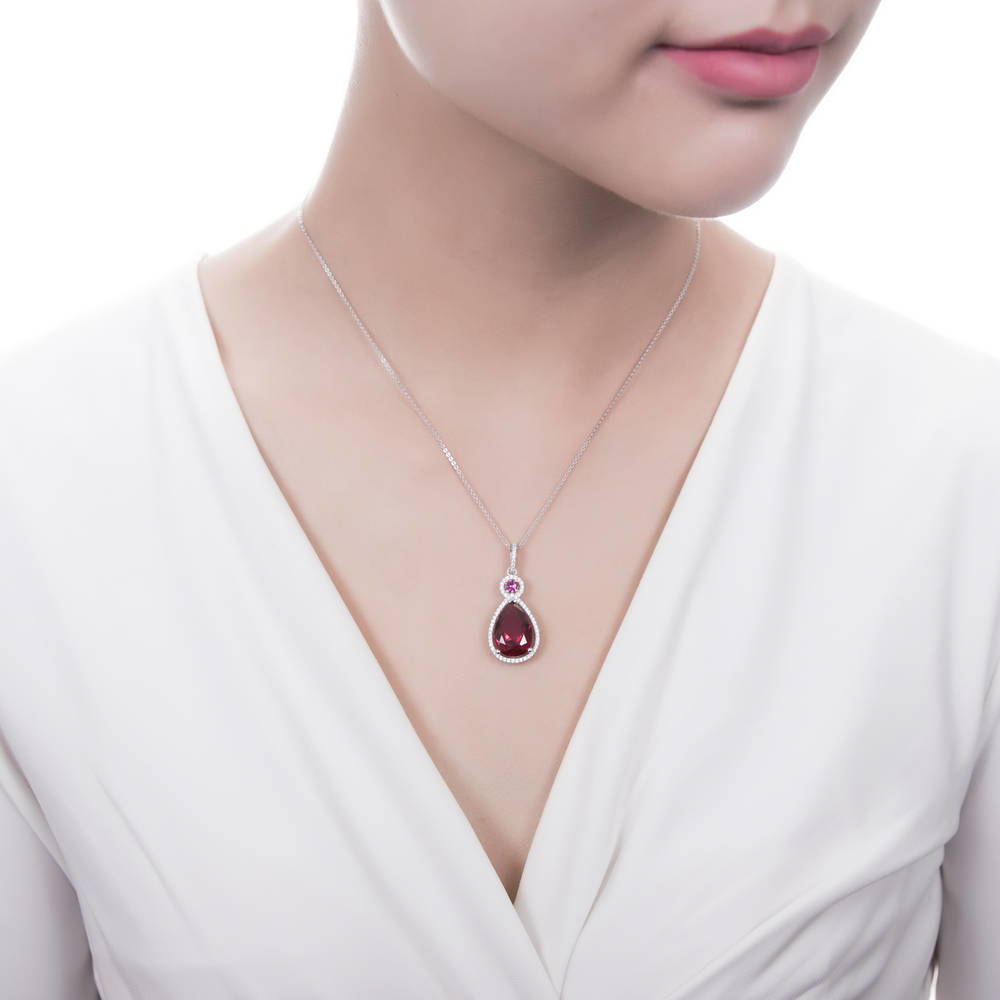 Model wearing Halo Simulated Ruby Pear CZ Pendant Necklace in Sterling Silver, 2 of 6