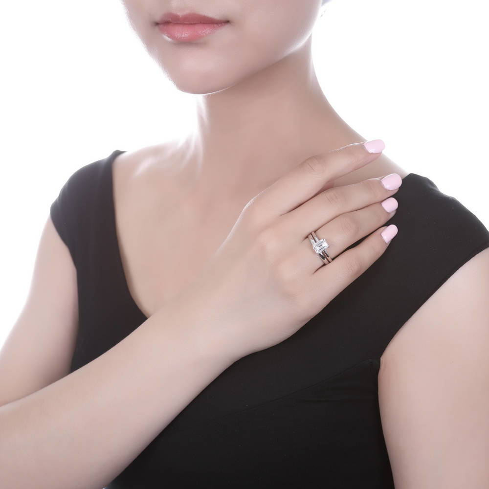 Model wearing Solitaire 2.1ct Emerald Cut CZ Ring Set in Sterling Silver