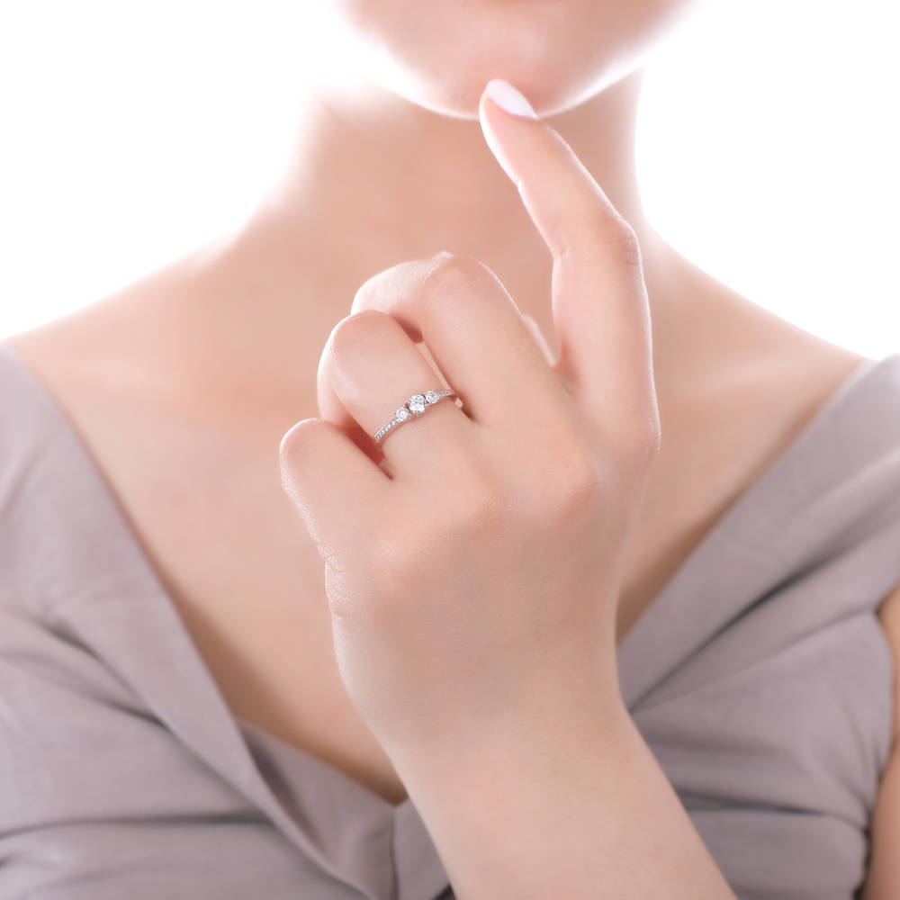 Model wearing 3-Stone Round CZ Ring in Rose Gold Plated Sterling Silver