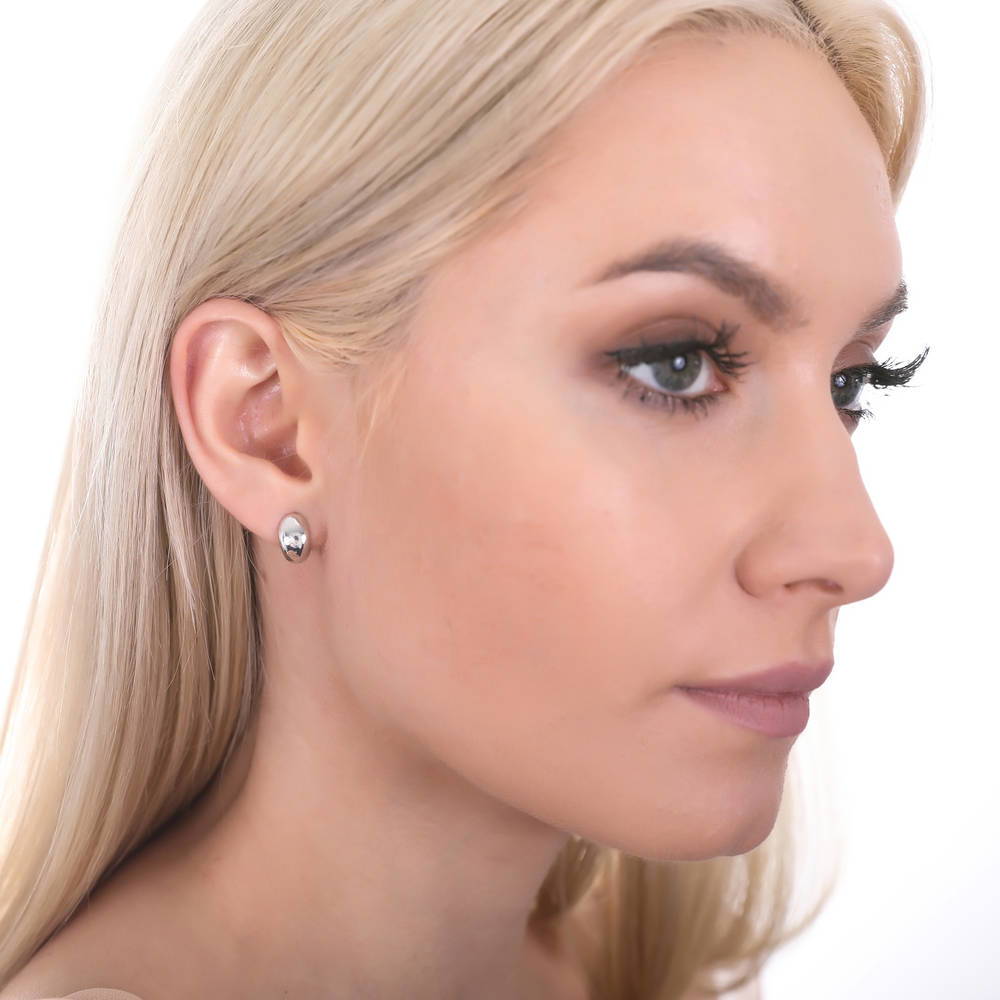Model wearing Dome Huggie Earrings in Sterling Silver, 2 Pairs