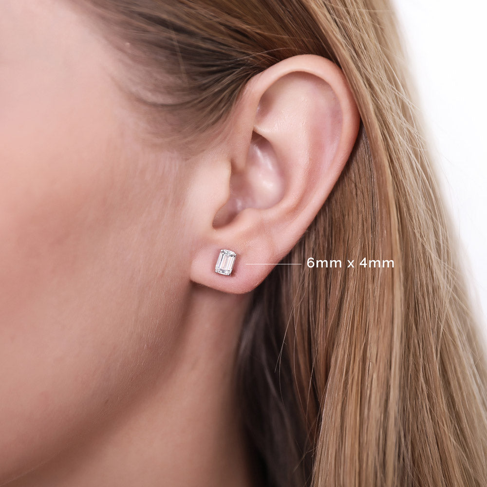 Model wearing Solitaire Emerald Cut CZ Stud Earrings in Sterling Silver