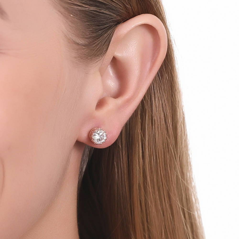 Model wearing Solitaire 1.6ct Crown Set Round CZ Stud Earrings in Sterling Silver