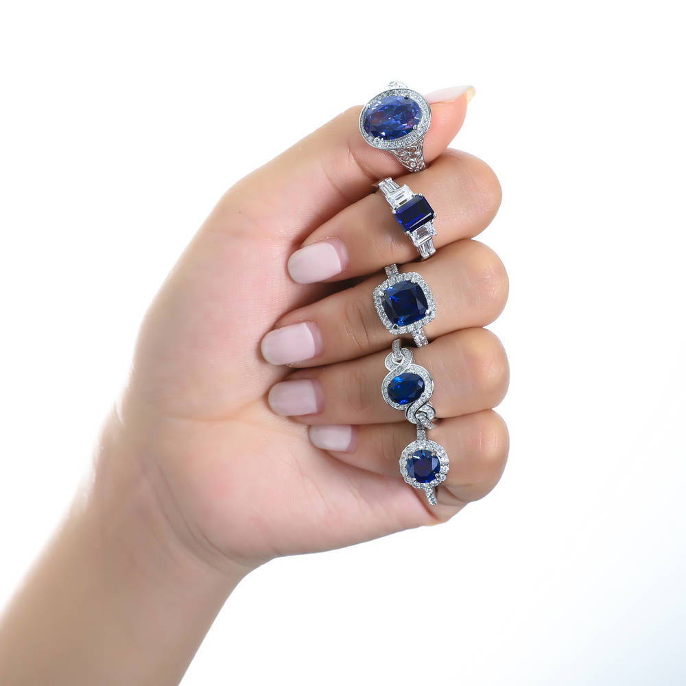 Model wearing Halo Simulated Blue Sapphire Cushion CZ Ring in Sterling Silver