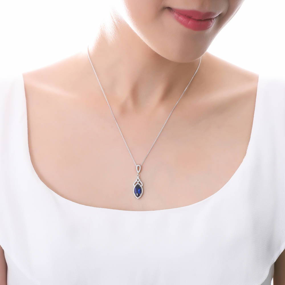 Model wearing Halo Simulated Blue Sapphire Marquise CZ Necklace in Sterling Silver, 2 of 6