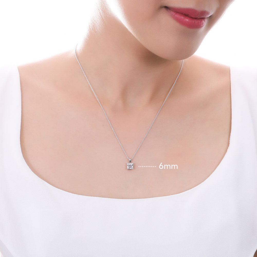 Model wearing Solitaire Princess CZ Pendant Necklace in Sterling Silver