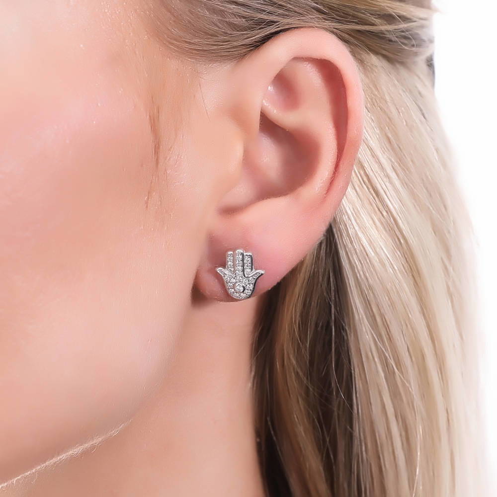 Model wearing Hamsa Hand CZ Stud Earrings in Sterling Silver