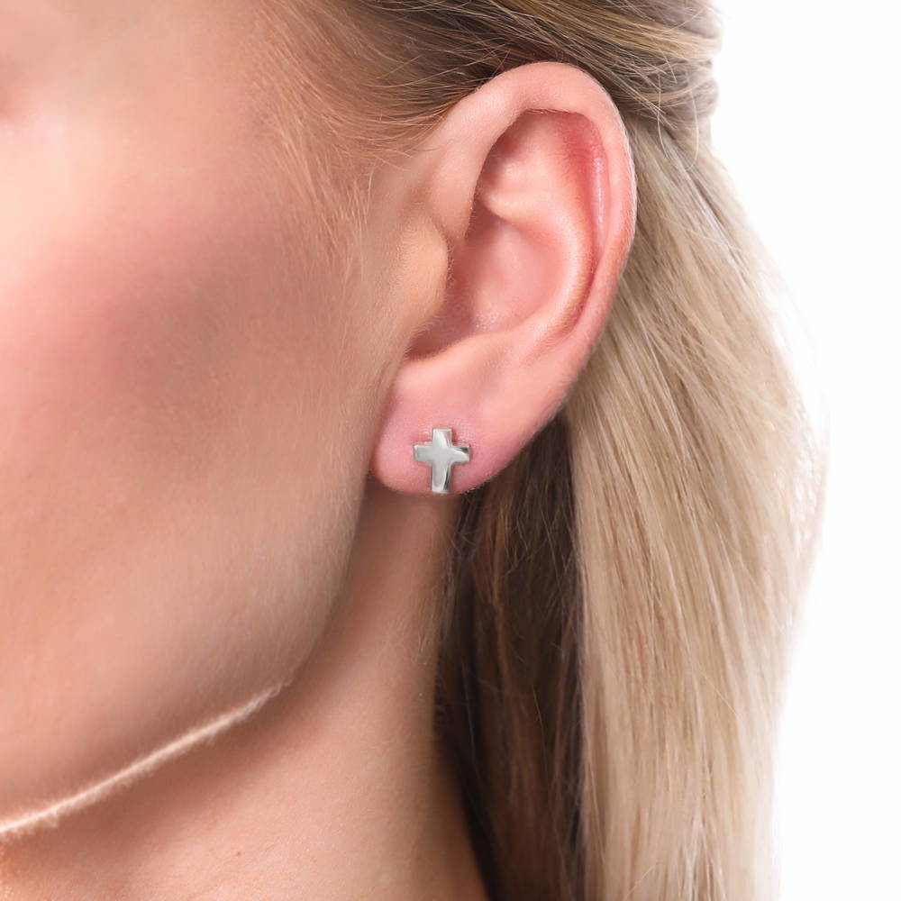 Model wearing Cross Stud Earrings in Sterling Silver