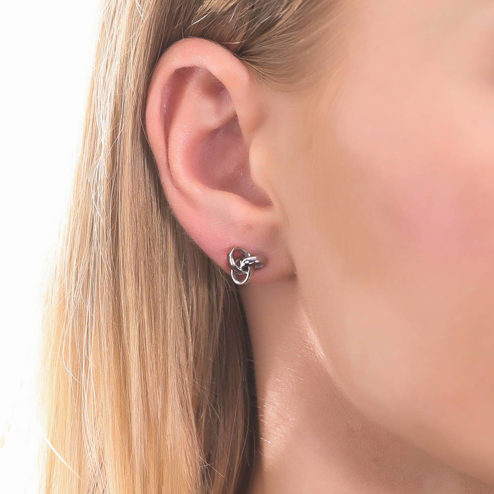 Model wearing Love Knot Stud Earrings in Sterling Silver