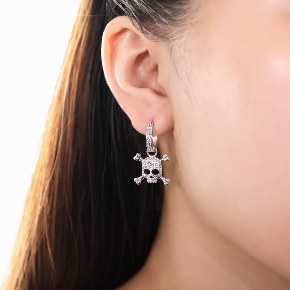 Model wearing Skull Bones CZ Dangle Earrings in Sterling Silver