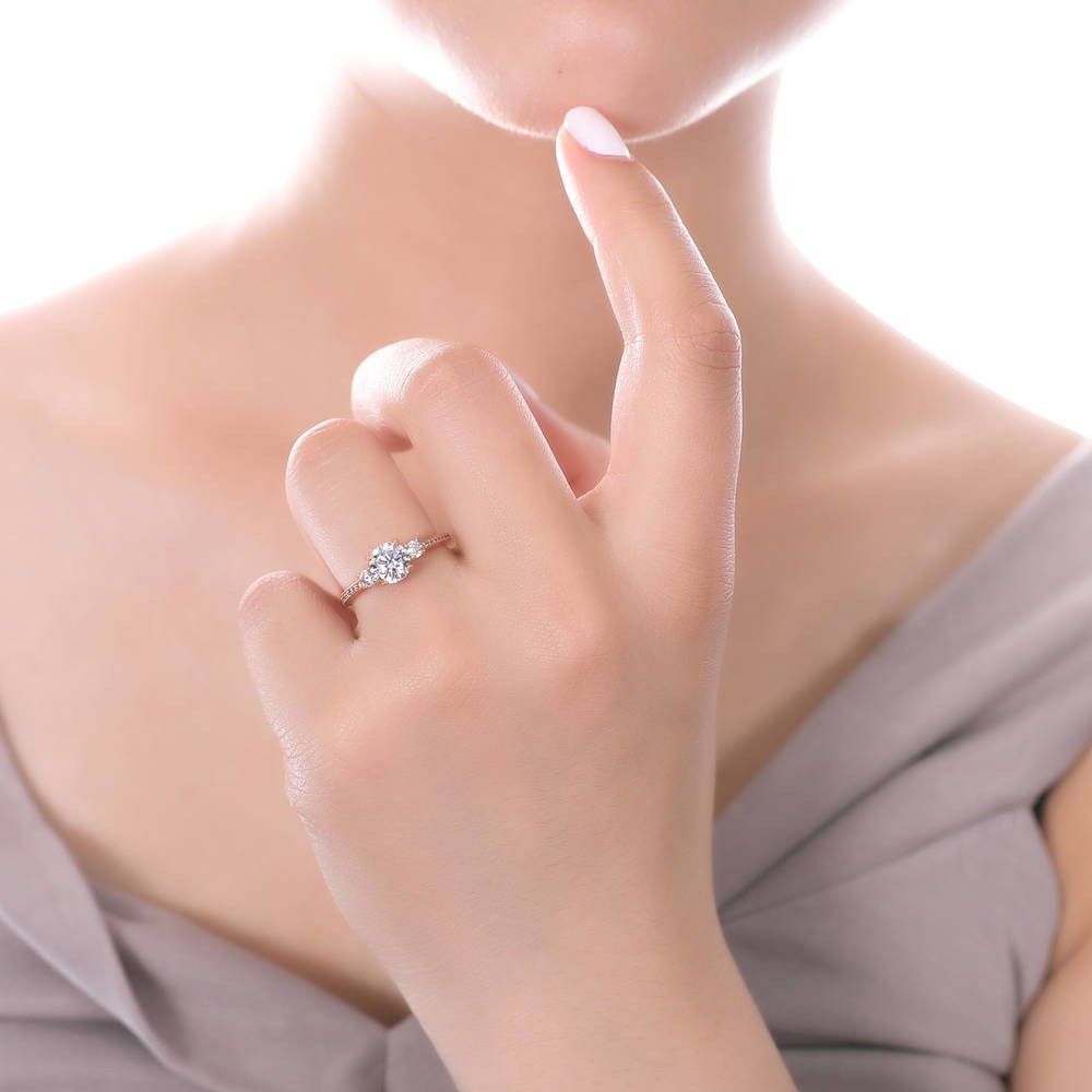 Model wearing 3-Stone Round CZ Ring in Rose Gold Plated Sterling Silver