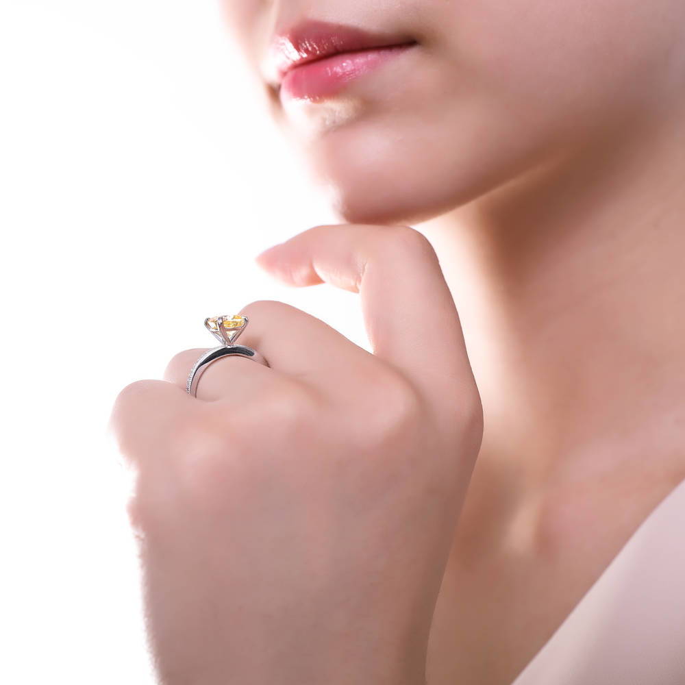Model wearing Solitaire 3ct Canary Yellow Cushion CZ Ring in Sterling Silver