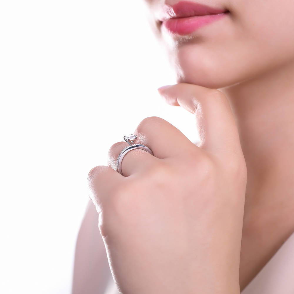 Model wearing Solitaire 1ct Emerald Cut CZ Ring in Sterling Silver