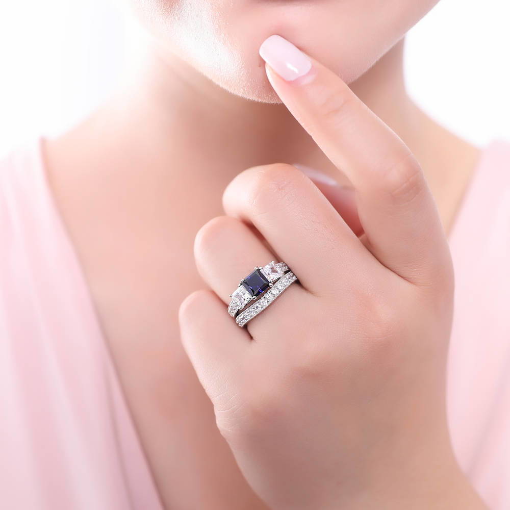 Model wearing 3-Stone Simulated Blue Sapphire Princess CZ Ring Set in Sterling Silver