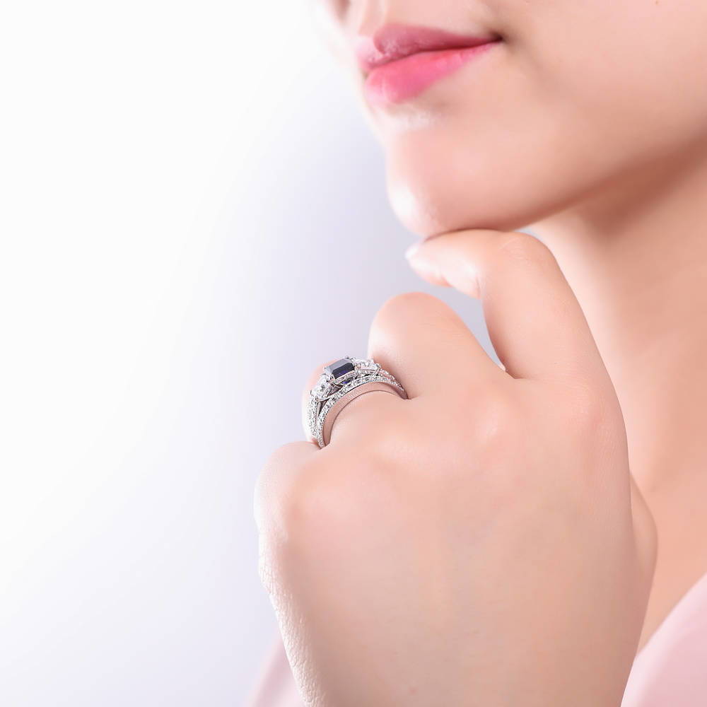 Model wearing 3-Stone Simulated Blue Sapphire Princess CZ Ring Set in Sterling Silver