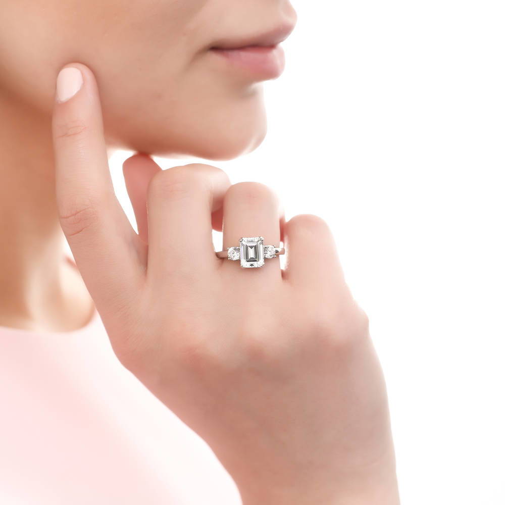 Model wearing 3-Stone Emerald Cut CZ Ring in Sterling Silver