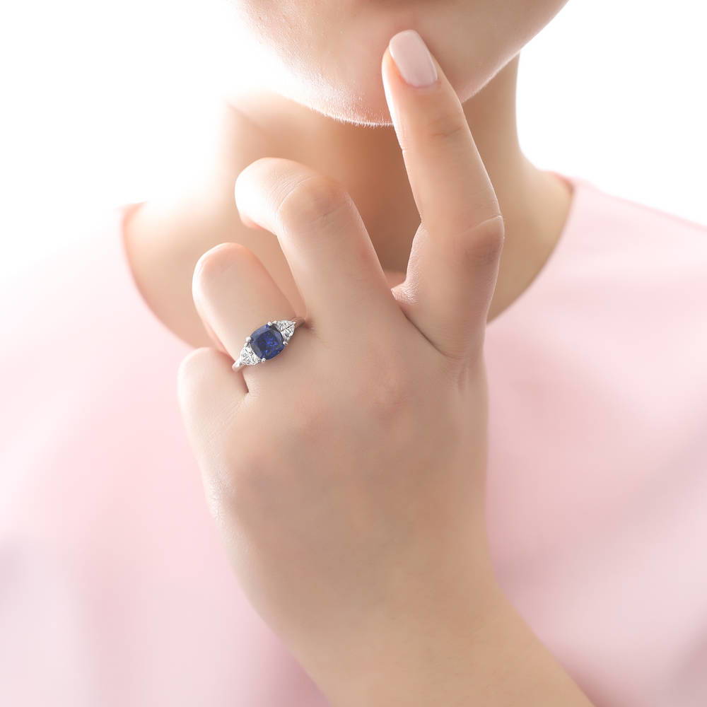 Model wearing 3-Stone Simulated Blue Sapphire Cushion CZ Ring in Sterling Silver