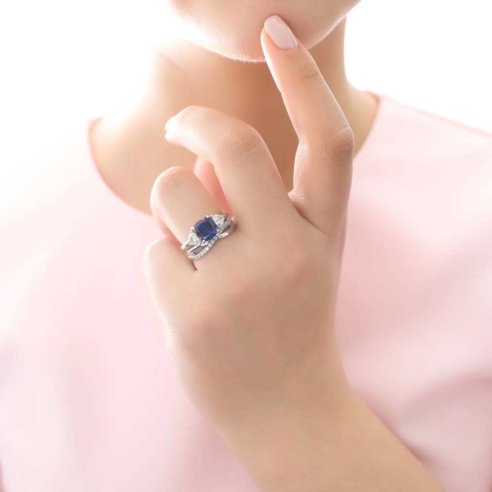 Model wearing 3-Stone Simulated Blue Sapphire Cushion CZ Ring Set in Sterling Silver